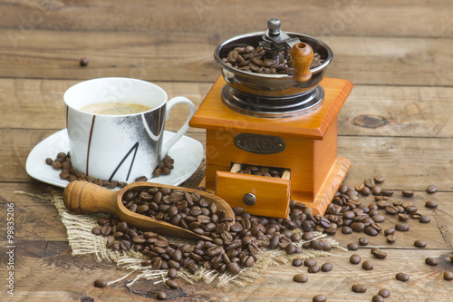 cup of coffee, coffee beans and old coffee grinder