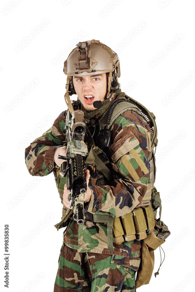 young ranger standing with a machine gun at white background young ranger standing with a machine gun at white background