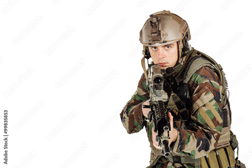 young ranger standing with a machine gun at white background young ranger standing with a machine gun at white background