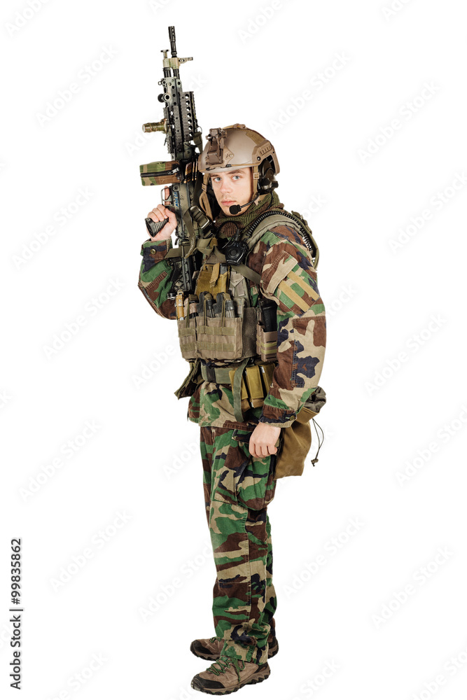 young ranger standing with a machine gun at white background young ranger standing with a machine gun at white background