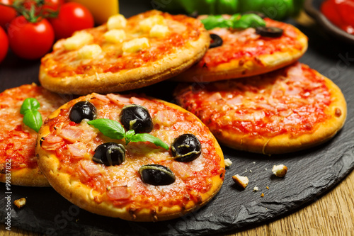 Mix of mini pizzas on a stone try photo