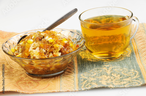 tea and jam-dried fruits, nuts with honey on tablecloth