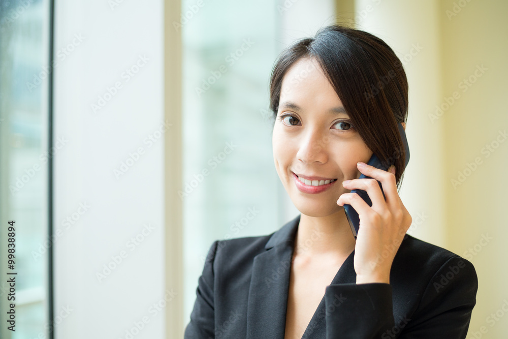 Businesswoman talk to cellphone at office Businesswoman talk to cellphone at office