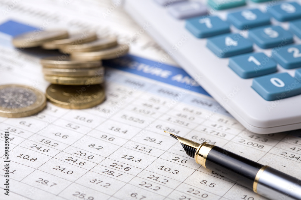 calculator, coins and pen on business report calculator, coins and pen on business report