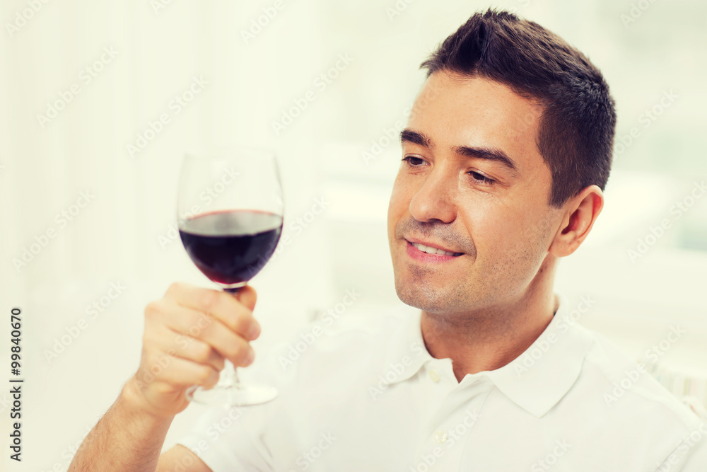 happy man drinking red wine from glass at home happy man drinking red wine from glass at home