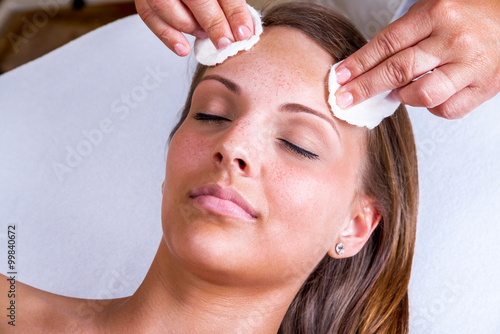 Freckles woman having a cosmetic treatment at the beauty salon.