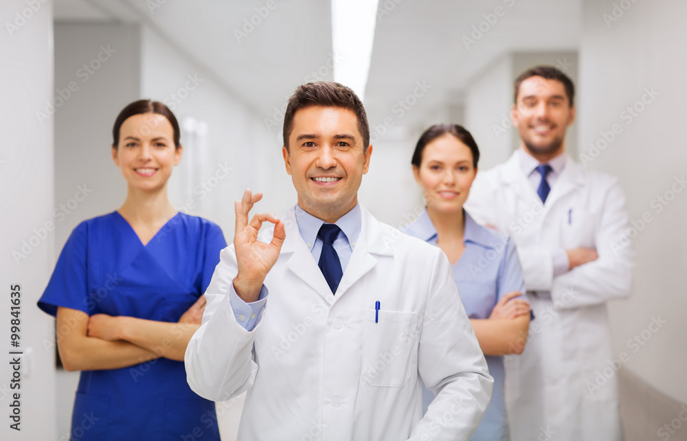 group of medics at hospital showing ok hand sign group of medics at hospital showing ok hand sign