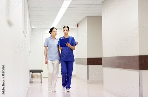 two medics or nurses at hospital with clipboard
