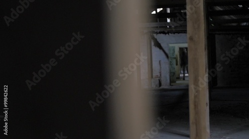 Wallpaper Mural Slow motion of vandal with mask and bar running in abandoned building Torontodigital.ca