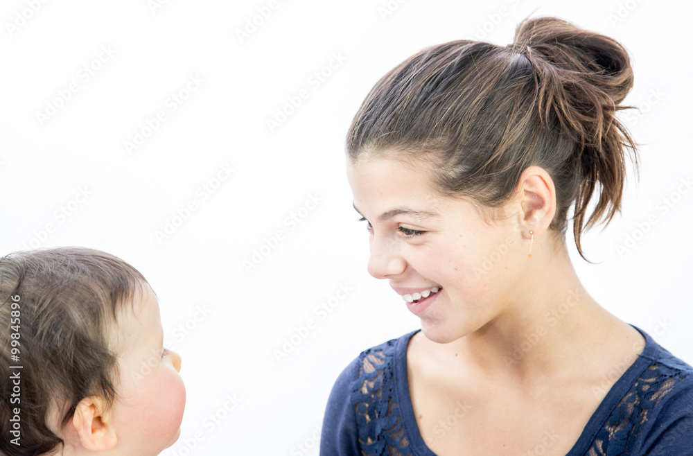 pretty girl playing with a baby on white background