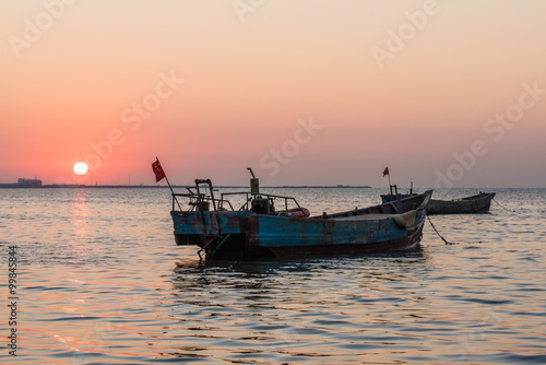 old fishing boat at sunset time -yantai china