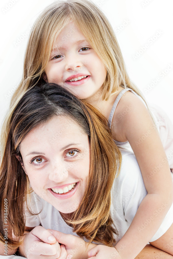 Closeup of a smiling young woman playing with her child on white background Closeup of a smiling young woman playing with her child on white background