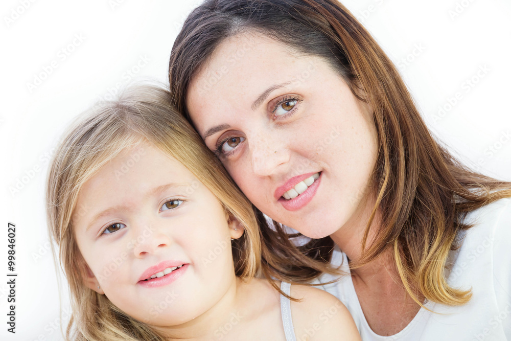 Closeup of a smiling young woman playing with her child on white background Closeup of a smiling young woman playing with her child on white background