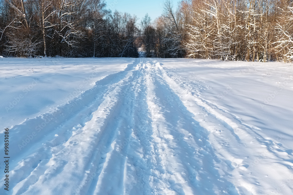 Winter landscape with road and a forest Winter landscape with road and a forest