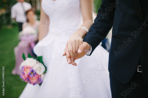 Bride and groom holding hands