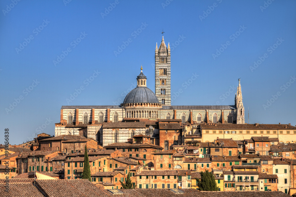The Cathedral of Siena on the skyline of the city in Tuscany, Italy. HDR