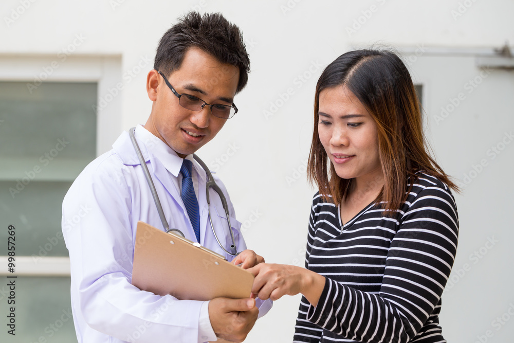 Doctor holding application form while consulting patient Doctor holding application form while consulting patient