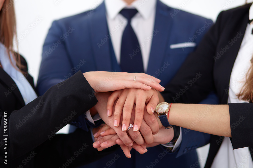Business people group joining hands and representing concept of friendship and teamwork Business people group joining hands and representing concept of friendship and teamwork