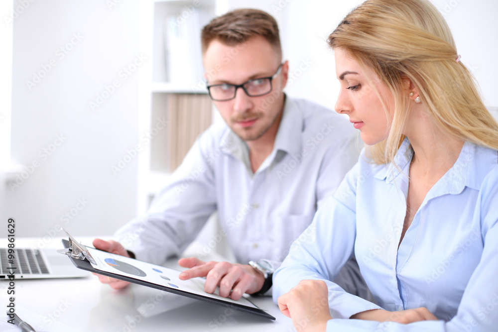 Two successful business partners working at meeting in office Two successful business partners working at meeting in office