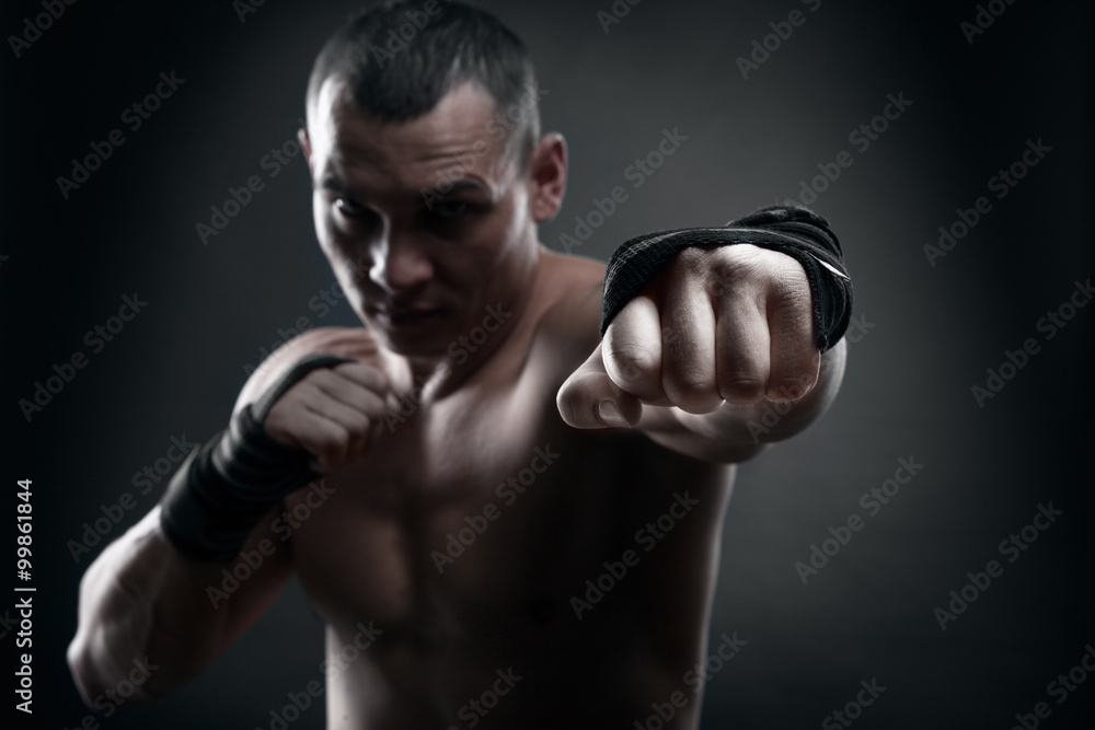 Fighter boxer and warrior's fist on black background