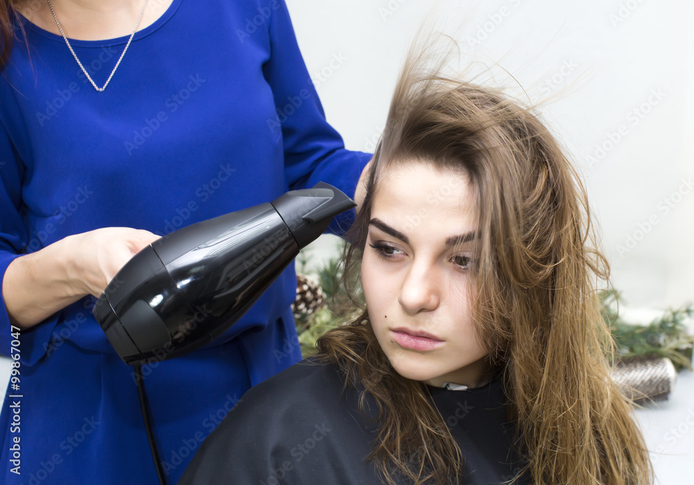 Fototapeta premium woman in a beauty salon doing hair