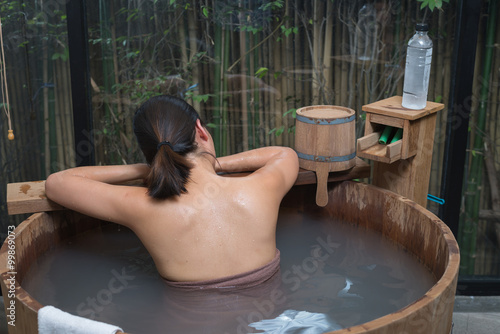 Onsen series : Unrecognizable woman in wooden bathtub