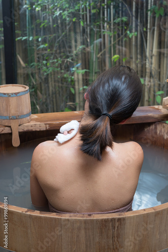 Onsen series : Unrecognizable woman in wooden bathtub