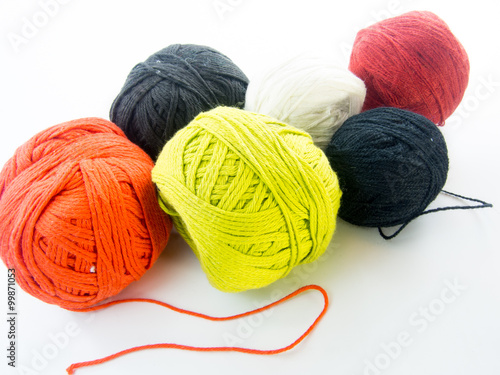 multi color balls of wool over white background