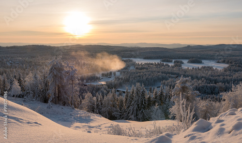 Sunset over winter forest