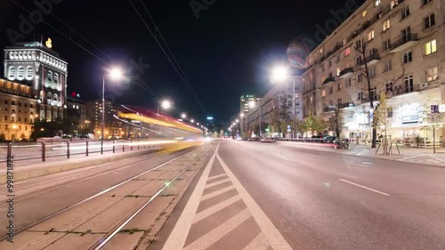 Time lapse of a trafficked road in Warsaw with trams in the night