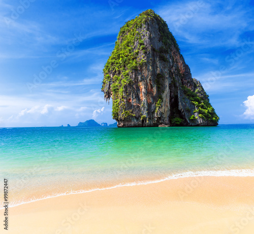 Idyllic sandy empty beach with exotic mountain on sea water on Thailand cost