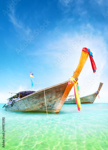 Vacation journey summer background. Traditional thai boats on turquoise water of tropical sea shore