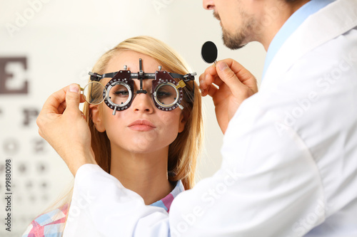 Adult male doctor examing adult female patient