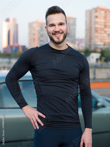 Free Download Confident male athlete standing with his hands on hips looking a - GFXLoad