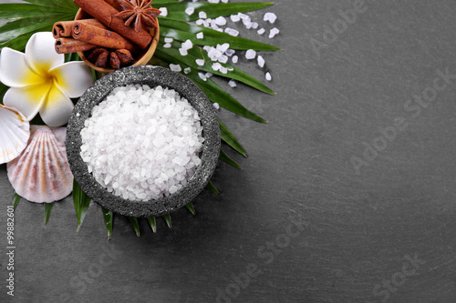 Beautiful spa setting on palm leaf on grey background photo