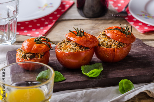 Baked tomatoes stuffed with herbs photo