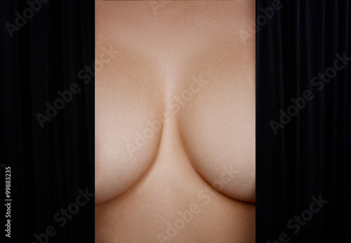 Topless woman body covering her big breast 