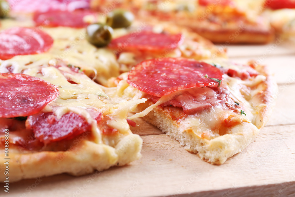 Delicious tasty pizza with cut slice, closeup Delicious tasty pizza with cut slice, closeup