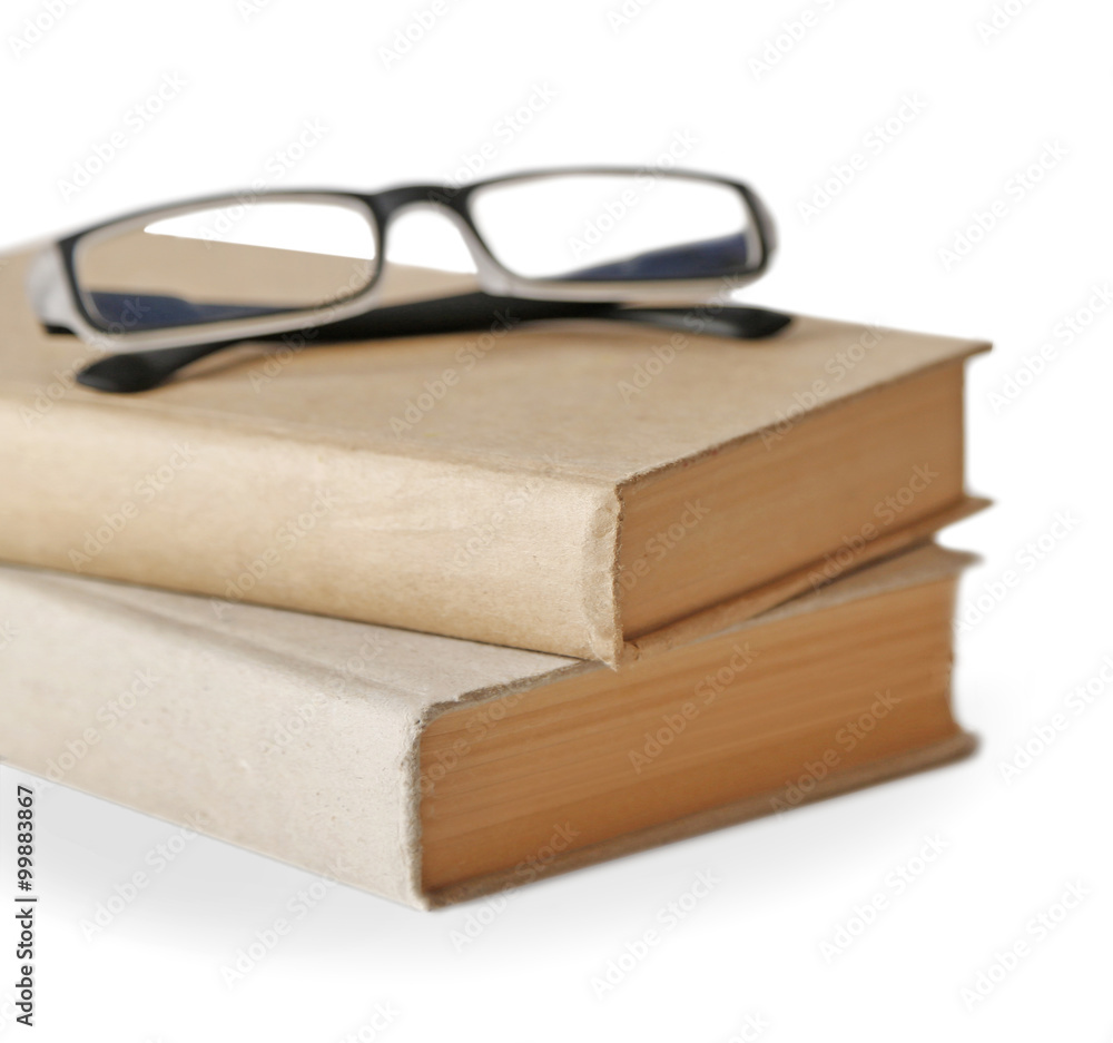 Hard covered books and eyeglasses on it isolated on white background Hard covered books and eyeglasses on it isolated on white background