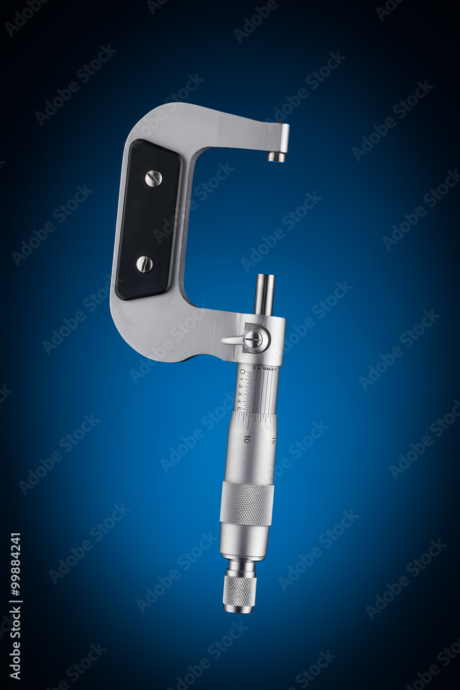 Open micrometer side view isolated on blue background Open micrometer side view isolated on blue background