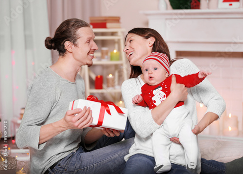 Happy family with gifts aga...