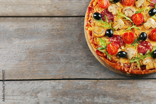 Delicious tasty pizza on wooden table