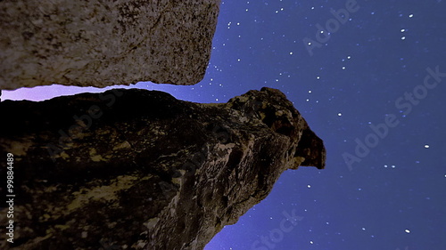 Vertical shot of Astronomical time-lapse looking up rock pillars at Mount Arbel. photo