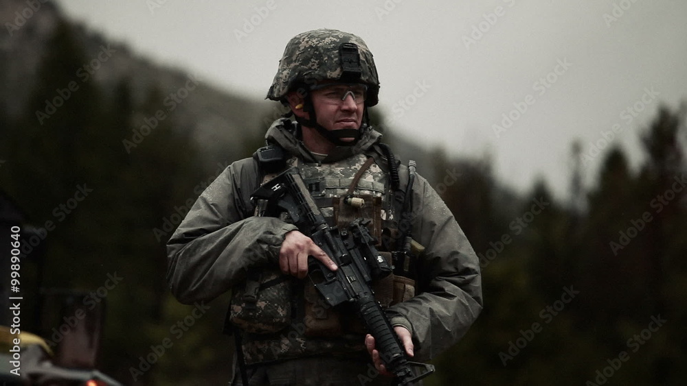 Shot of soldier looking around and then looking at camera. Shot of soldier looking around and then looking at camera.