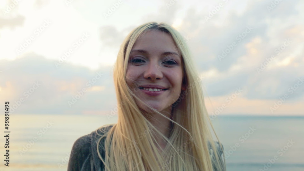Woman pose on beach at sunset Woman pose on beach at sunset