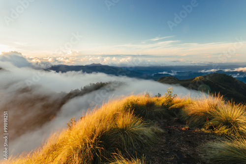 Beautiful sunrise in the mountains with flowing clouds