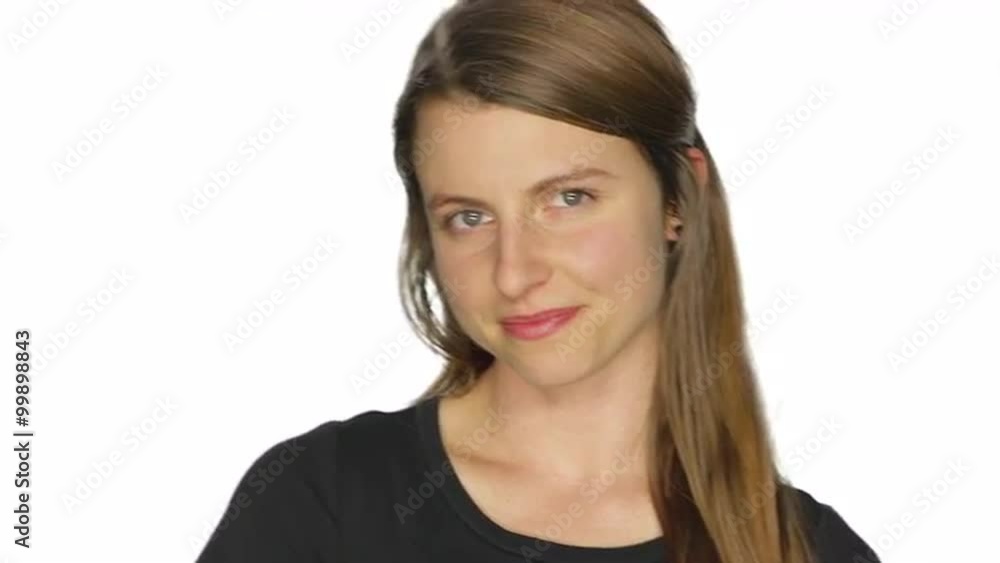 Beautiful young woman smiles proudly, on a white studio background Beautiful young woman smiles proudly, on a white studio background