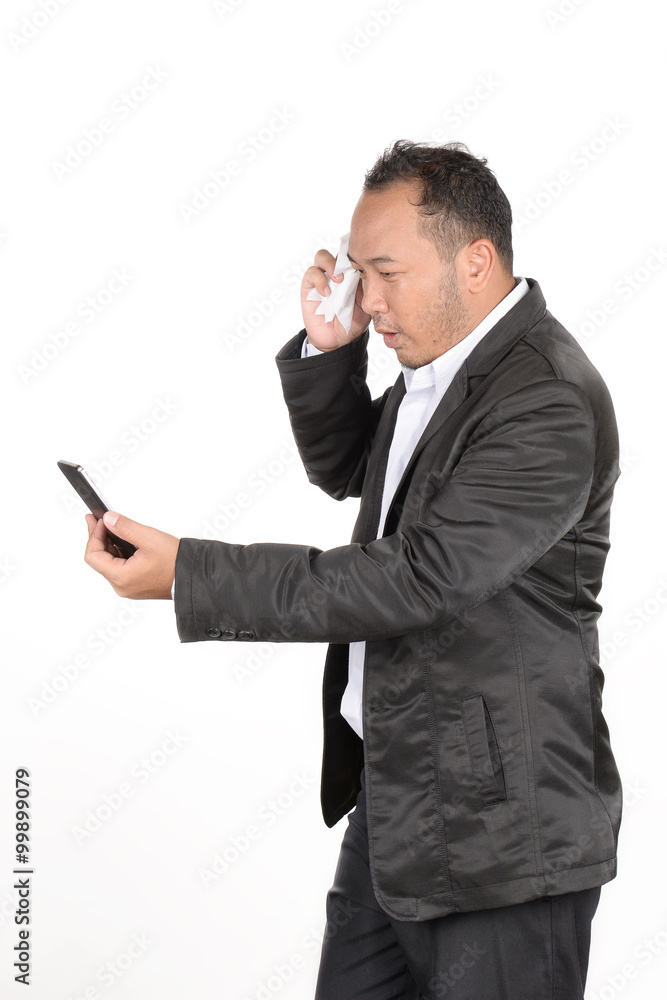 Businessmen are serious about the check stocks from a phone. Businessmen are serious about the check stocks from a phone.
