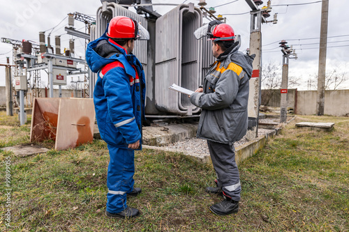 Electricians on high voltage substation