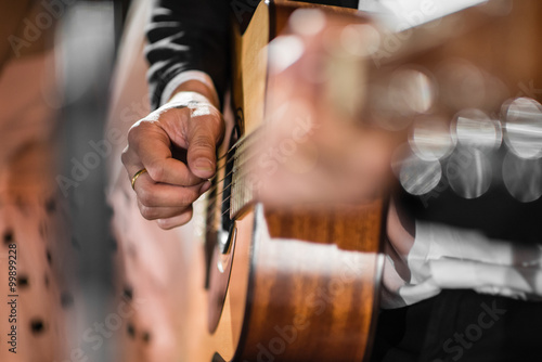 Closeup hand playing acoustic guitar